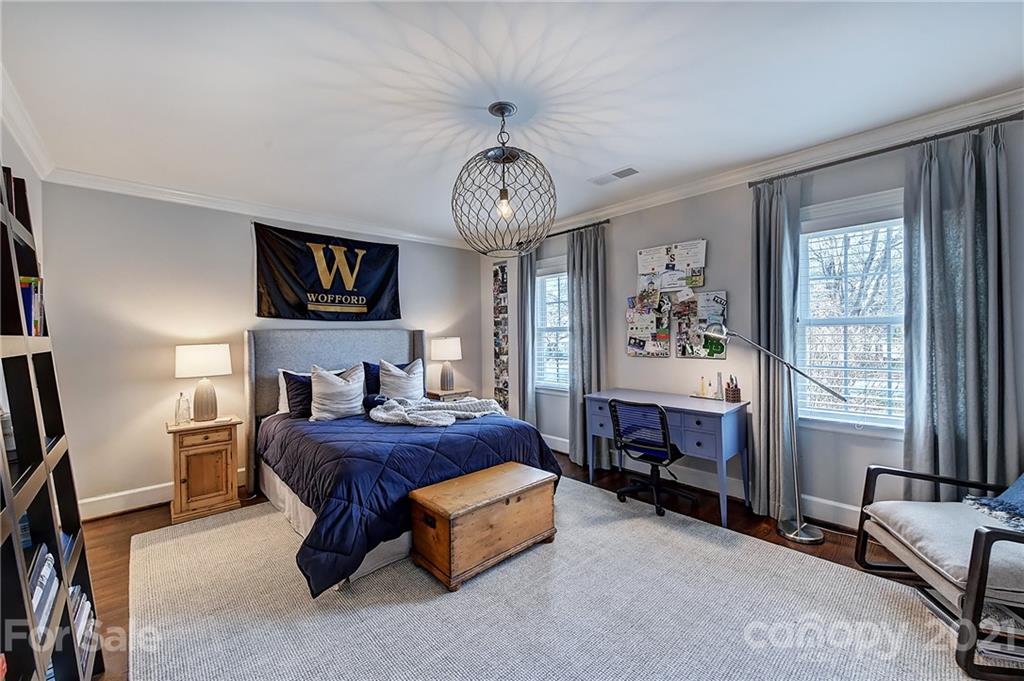 3400 Sharon Road Charlotte, NC 28211 - Photo 18 of 38 a spacious bedroom with a bed and a chandelier