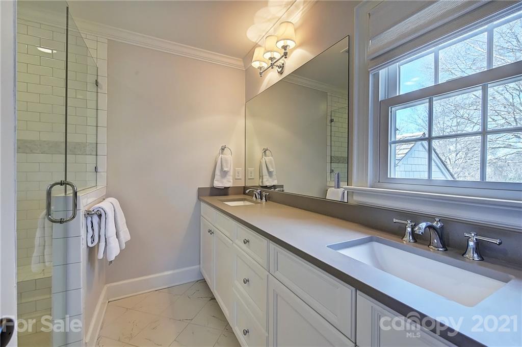 3400 Sharon Road Charlotte, NC 28211 - Photo 19 of 38 a bathroom with a double vanity sink and a mirror