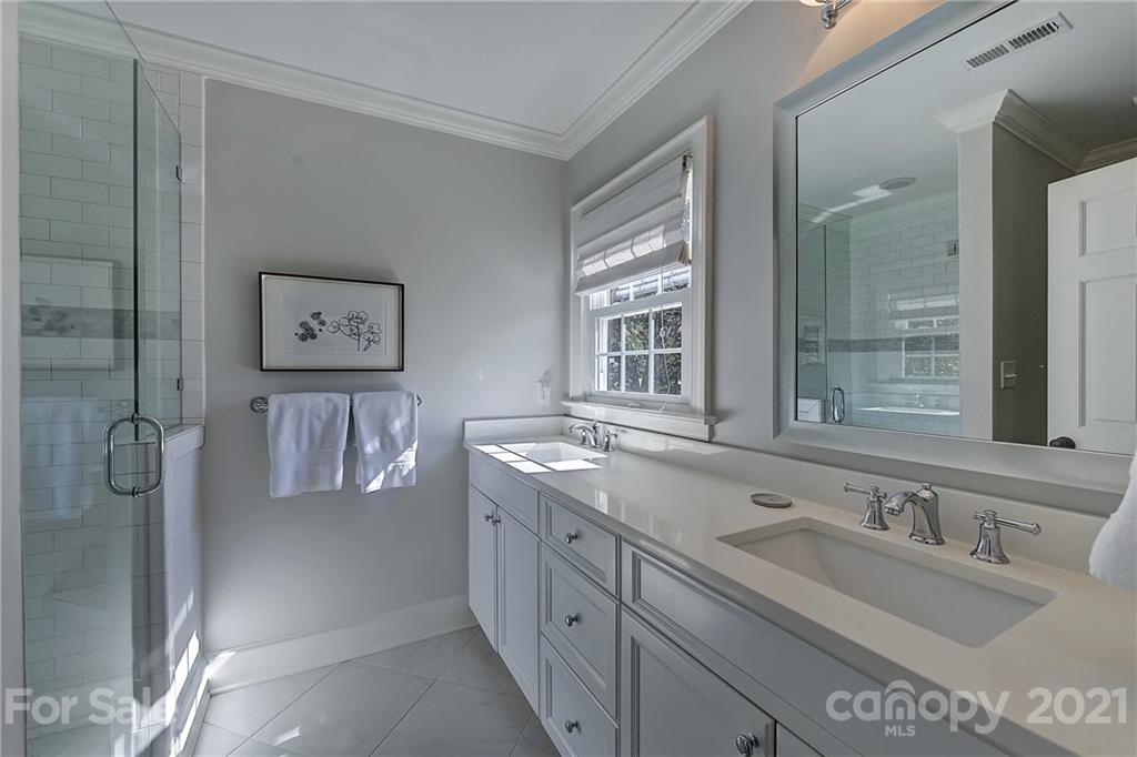 3400 Sharon Road Charlotte, NC 28211 - Photo 21 of 38 a bathroom with a sink double vanity and a shower
