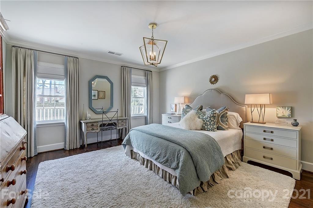 3400 Sharon Road Charlotte, NC 28211 - Photo 22 of 38 a bedroom with a bed and a chandelier