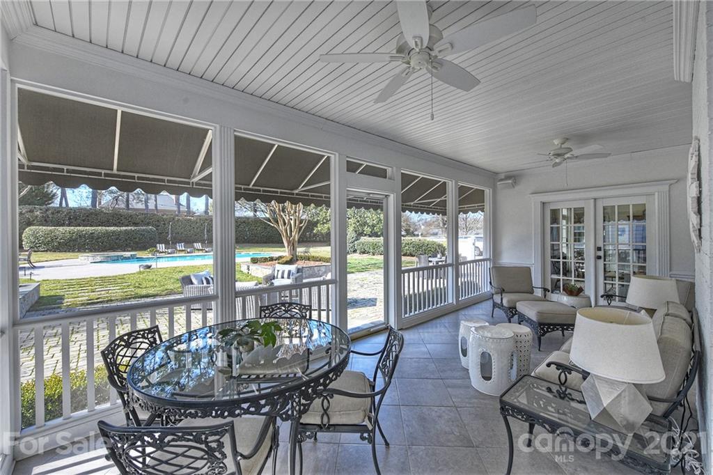 3400 Sharon Road Charlotte, NC 28211 - Photo 26 of 38 a dining room with furniture large windows and wooden floor