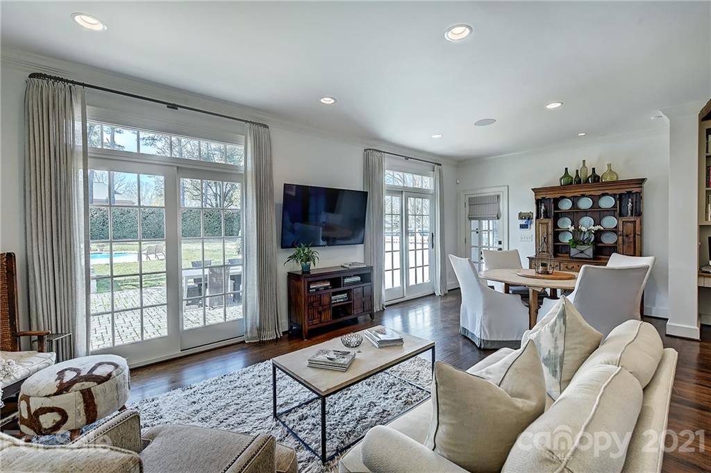 3400 Sharon Road Charlotte, NC 28211 - Photo 8 of 38 a living room with furniture a flat screen tv and a floor to ceiling window