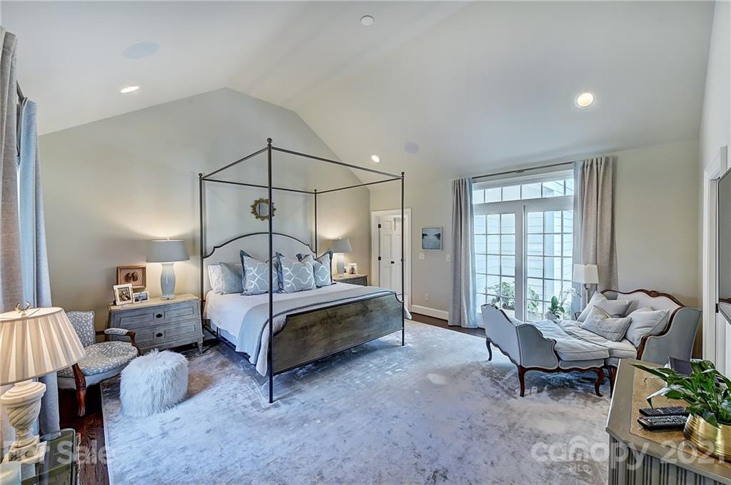 3400 Sharon Road Charlotte, NC 28211 - Photo 10 of 38 a spacious bedroom with a bed and a chandelier