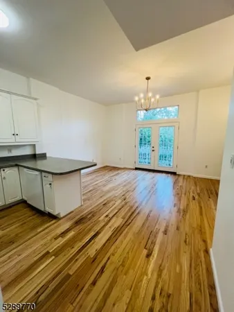 a view of a room with wooden floor and staircase
