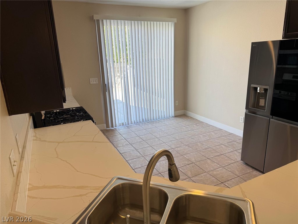 3962 Coyote Ridge Court Las Vegas, NV 89129 - Photo 8 of 35 Culinary delights await in this modern kitchen with pristine countertops and integrated appliances.