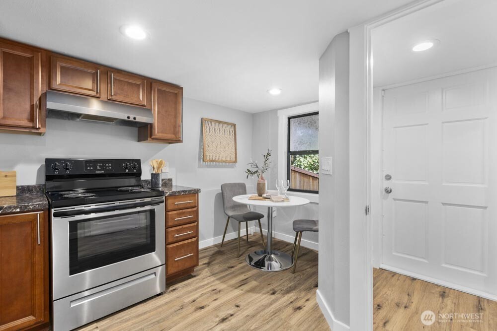 5926 34th Avenue Southwest Seattle, WA 98126 - Photo 21 of 36 a kitchen with stainless steel appliances granite countertop a stove and a refrigerator