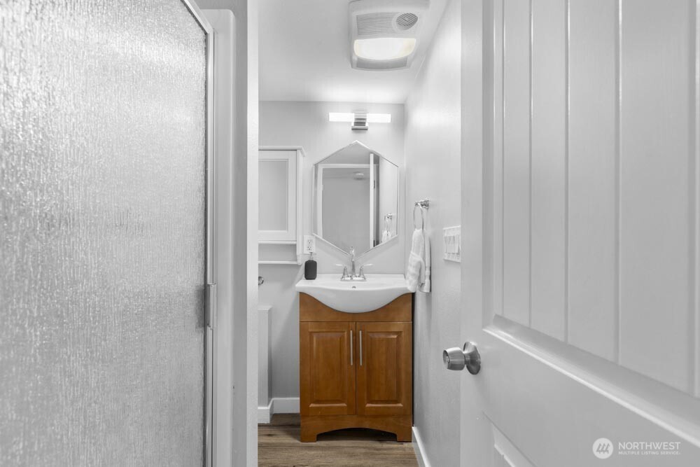 5926 34th Avenue Southwest Seattle, WA 98126 - Photo 22 of 36 a bathroom with a sink a mirror and a shower