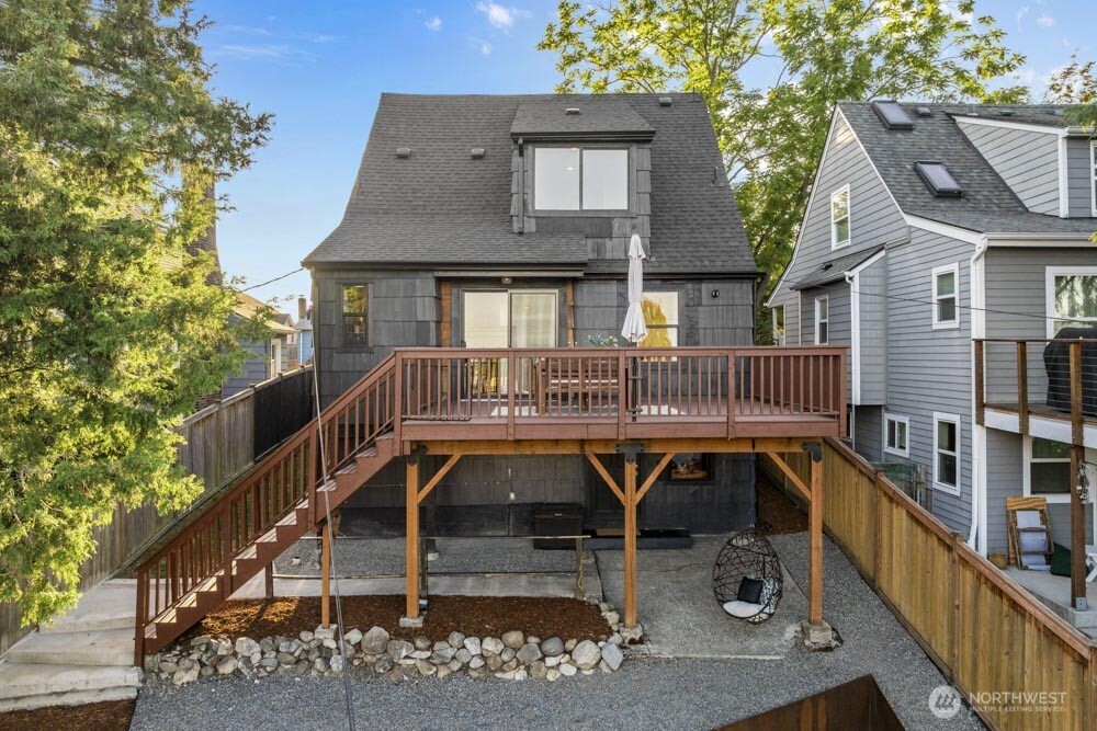 5926 34th Avenue Southwest Seattle, WA 98126 - Photo 26 of 36 a view of a house with wooden deck and furniture