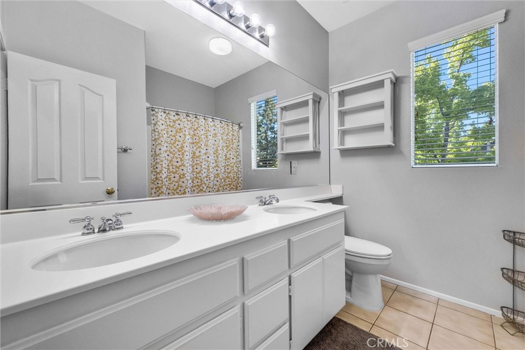 11499 Bridgeway Drive Riverside, CA 92505 - Photo 47 of 70 a bathroom with a sink double vanity granite and a toilet