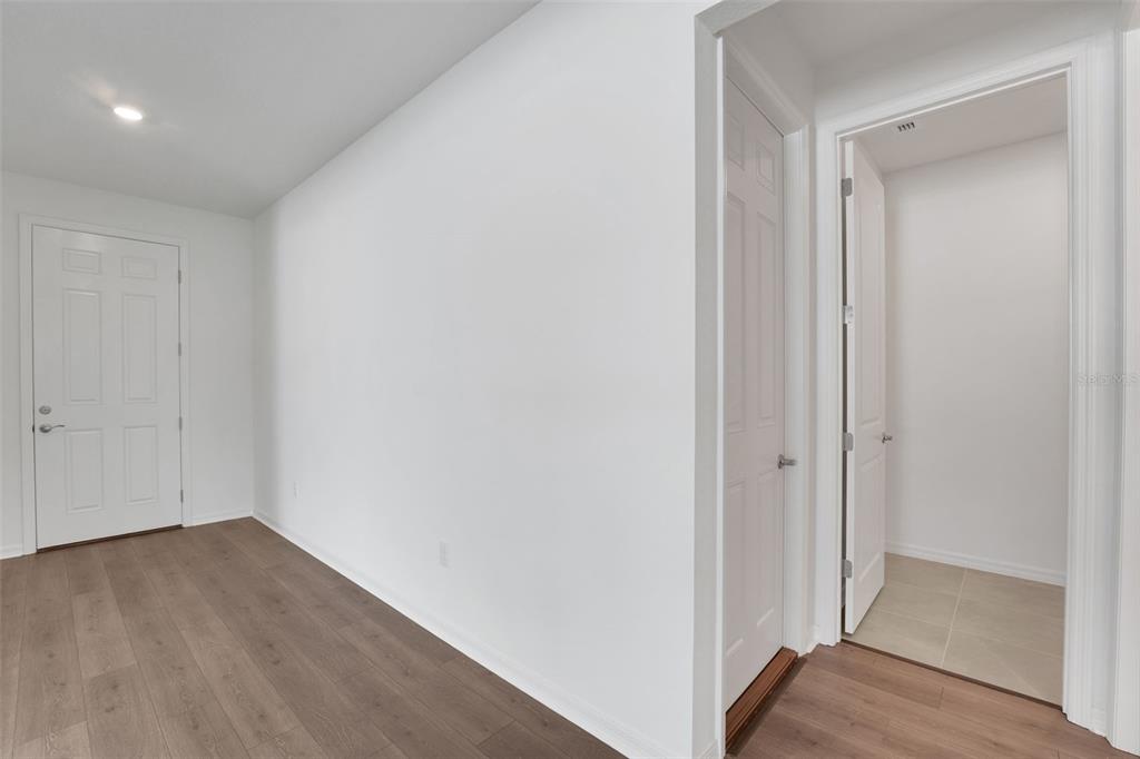 35151 Tuscan Hill Road Dade City, FL 33525 - Photo 11 of 38 a view of a hallway with wooden floor