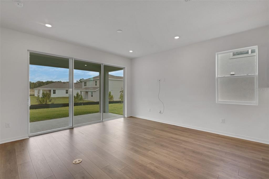 35151 Tuscan Hill Road Dade City, FL 33525 - Photo 15 of 38 a view of an empty room with wooden floor and a window