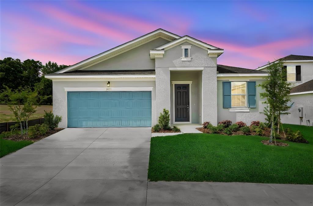 35151 Tuscan Hill Road Dade City, FL 33525 - Photo 2 of 38 a front view of a house with a yard and garage