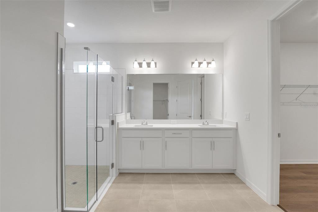 35151 Tuscan Hill Road Dade City, FL 33525 - Photo 26 of 38 a bathroom with a double vanity sink and mirror