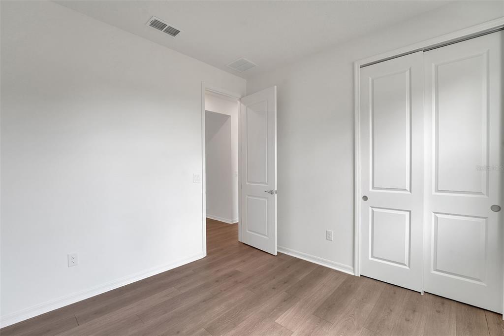 35151 Tuscan Hill Road Dade City, FL 33525 - Photo 32 of 38 a view of an empty room and wooden floor
