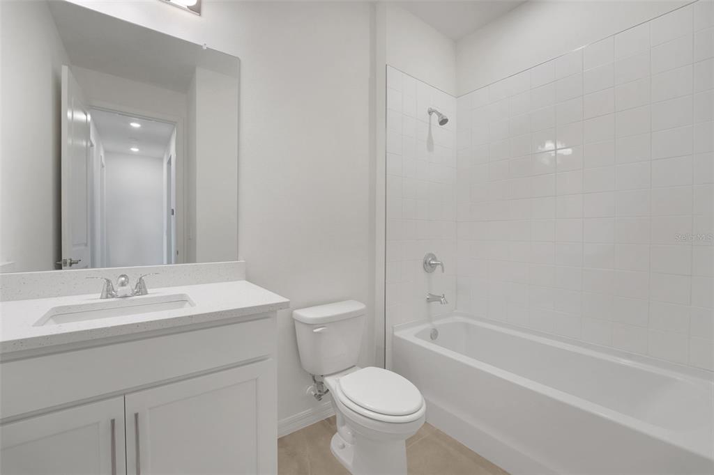 35151 Tuscan Hill Road Dade City, FL 33525 - Photo 33 of 38 a bathroom with a sink a toilet and shower