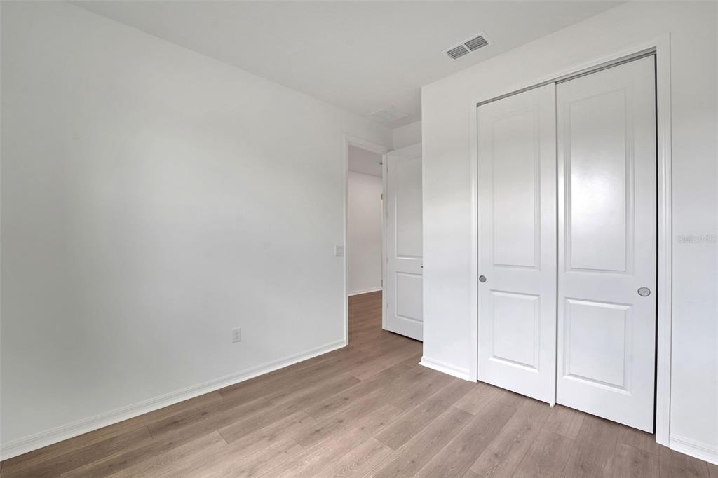 35151 Tuscan Hill Road Dade City, FL 33525 - Photo 7 of 38 a view of an empty room and wooden floor