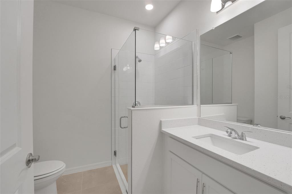 35151 Tuscan Hill Road Dade City, FL 33525 - Photo 9 of 38 a bathroom with a sink a toilet and shower