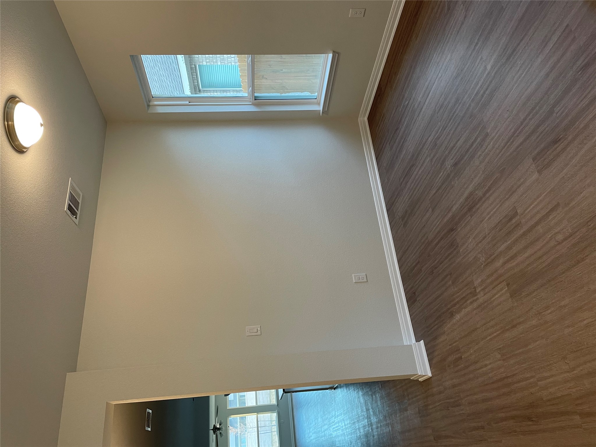 3908 Birdwatch Loop, Unit 56 Pflugerville, TX 78660 - Photo 29 of 30 a view of an empty room with wooden floor and a window