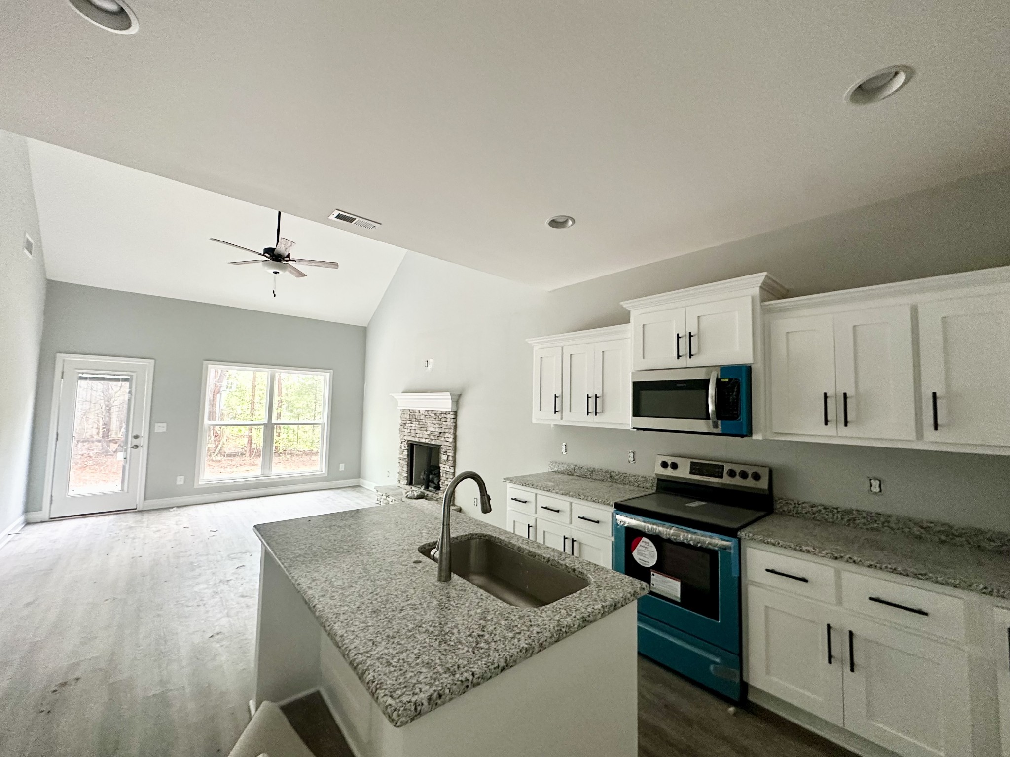 167 Providence Road Pelham, TN 37366 - Photo 4 of 15 a kitchen with granite countertop a sink a counter top space appliances and cabinets