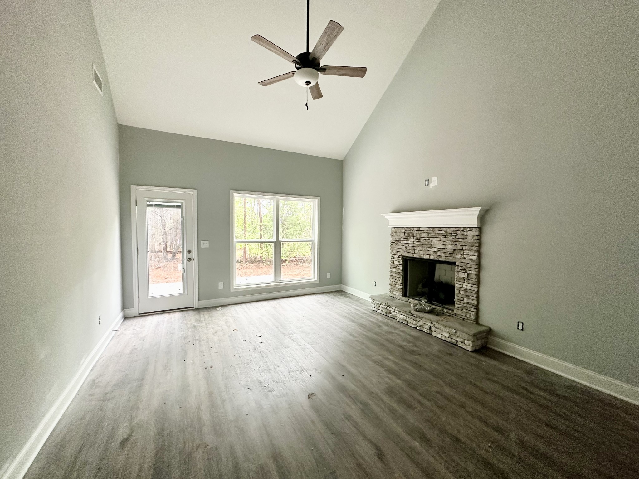 167 Providence Road Pelham, TN 37366 - Photo 6 of 15 a view of empty room with a fireplace and wooden floor