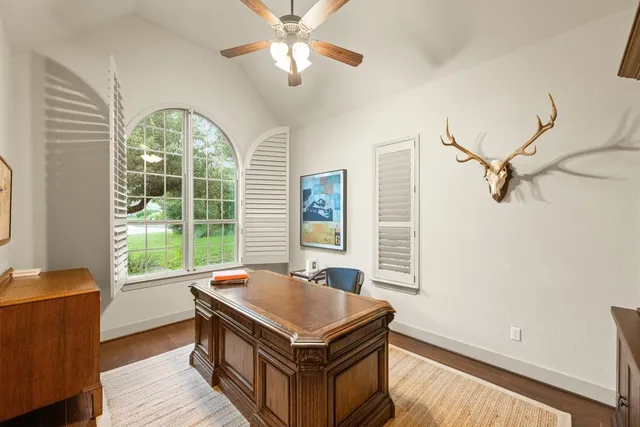 a living room with a bed furniture and a large window