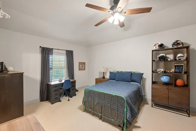 a bedroom with a bed and a chandelier