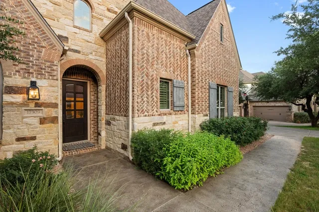 front view of a house with potted plants