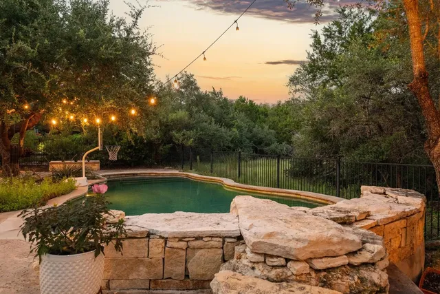 a view of backyard with hardwood and lake view
