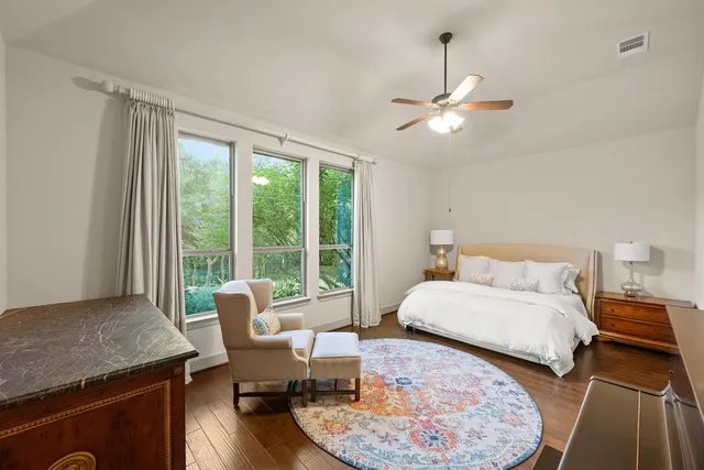 a bedroom with furniture and a large window