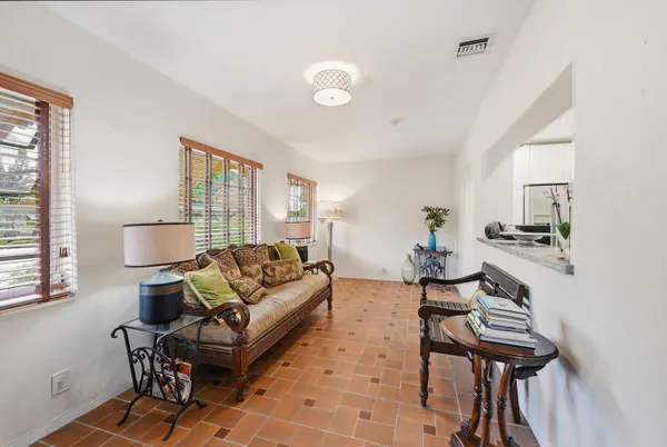 a living room with furniture and a piano