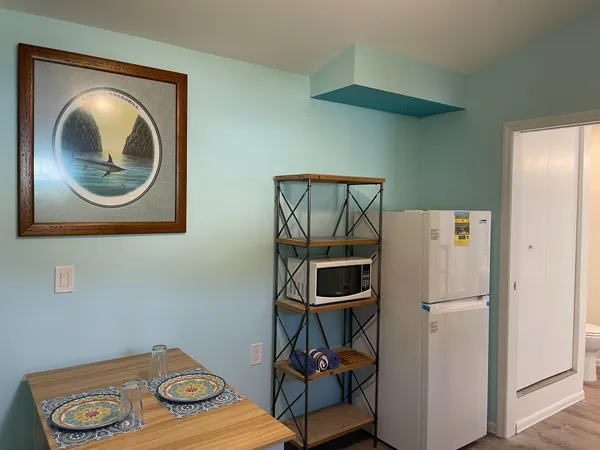a kitchen with a refrigerator and a stove