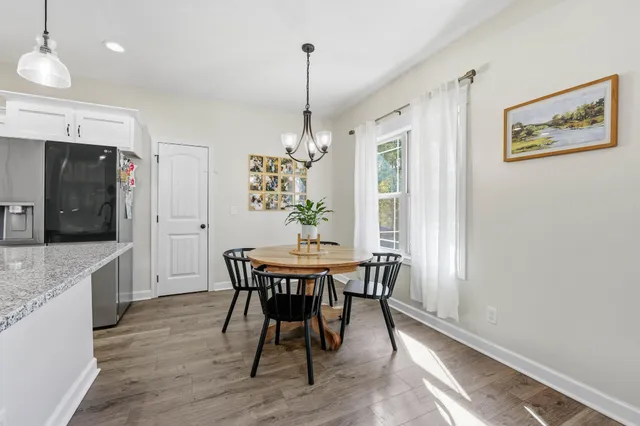 a view of a dining room with furniture window and wooden floor