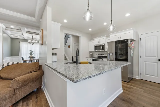 a large kitchen with stainless steel appliances kitchen island granite countertop a large counter top stainless steel appliances and cabinets