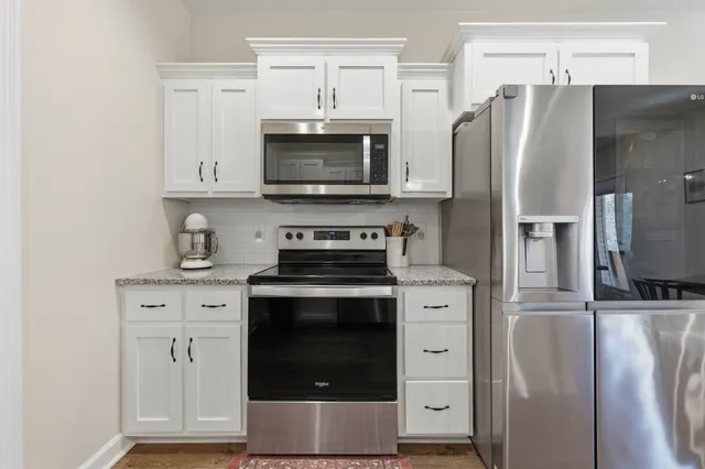 a kitchen with stainless steel appliances a refrigerator stove and microwave