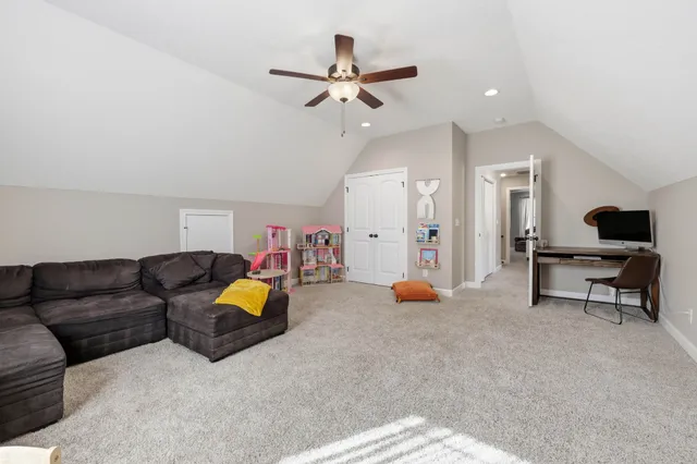 a living room with furniture and kitchen view