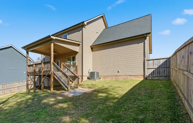 a view of an house with backyard and furniture