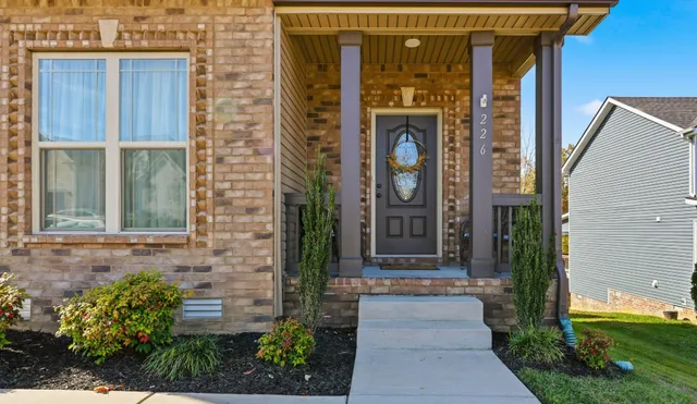 a front view of a house with a garden
