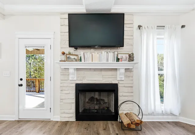 a living room with a fireplace and a flat screen tv