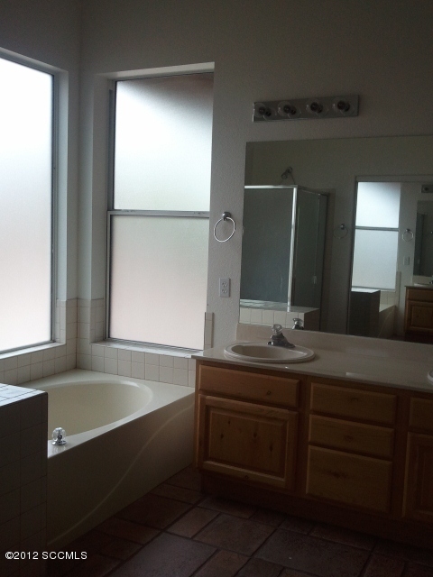 92 Back Nine Terrace Rio Rico, AZ 85648 - Photo 7 of 10 a bathroom with a bathtub sink and mirror