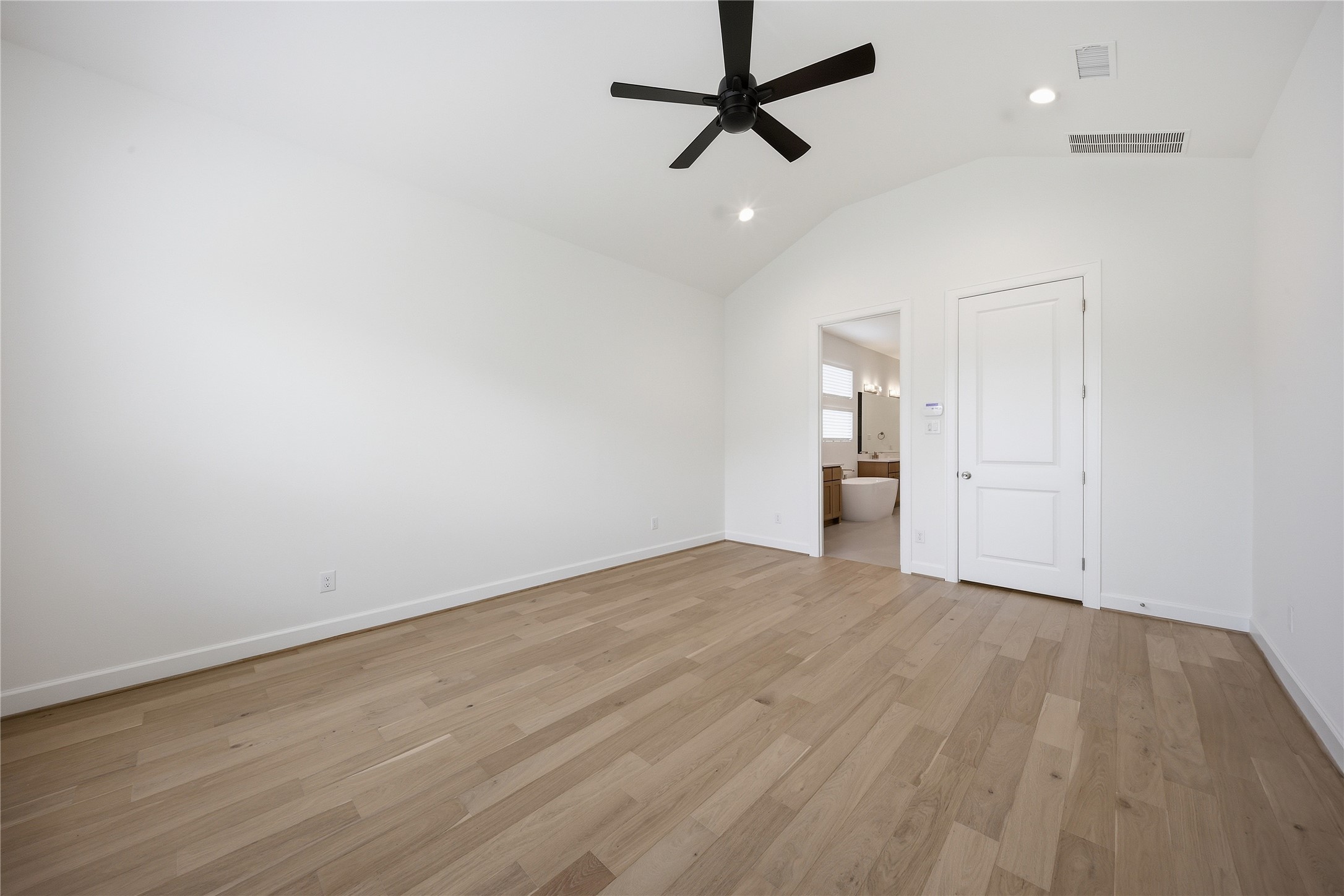 416 Venado View Court Conroe, TX 77304 - Photo 16 of 34 Primary suite featuring soaring ceilings, abundant natural light and wood flooring throughout