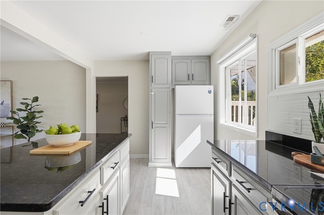 9207 Mapleway Road Richmond, VA 23229 - Photo 16 of 36 Kitchen featuring white appliances, light gray cab