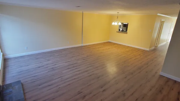 a view of a room with wooden floor