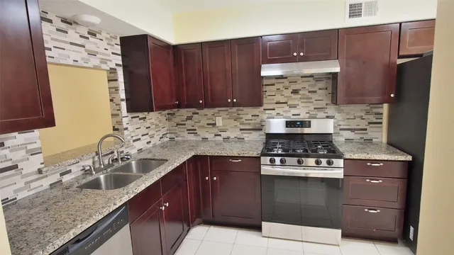 a kitchen with a stove a sink and a microwave