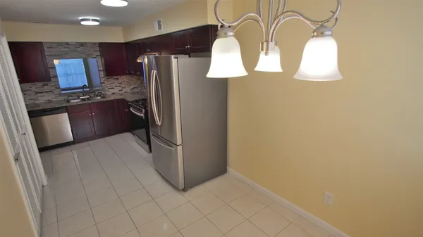 a kitchen with stainless steel appliances a refrigerator and a stove