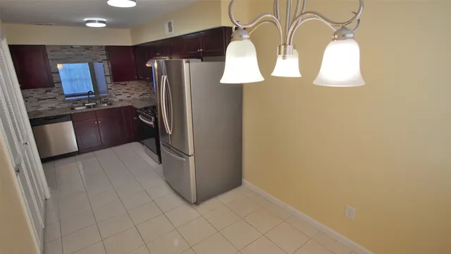 a kitchen with stainless steel appliances a refrigerator and a stove