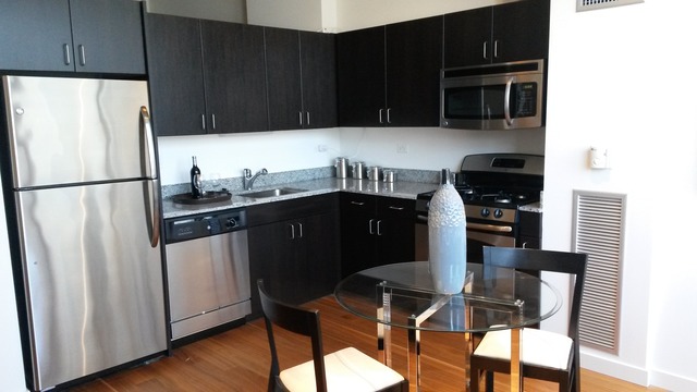 235 West Van Buren Street, Unit 3620 Chicago, IL 60607 - Photo 5 of 12 a kitchen with stainless steel appliances a refrigerator a stove a sink and cabinets
