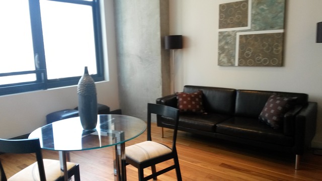 235 West Van Buren Street, Unit 3620 Chicago, IL 60607 - Photo 7 of 12 a living room with furniture and a window