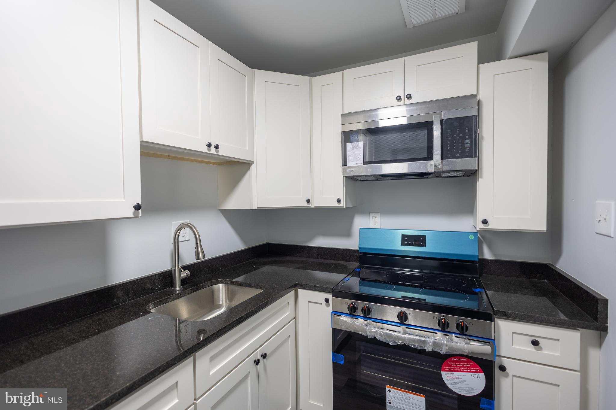 1300-1302 Morris Road Southeast, Unit A6 Washington, DC 20020 - Photo 11 of 13 a kitchen with stainless steel appliances granite countertop a sink and a stove