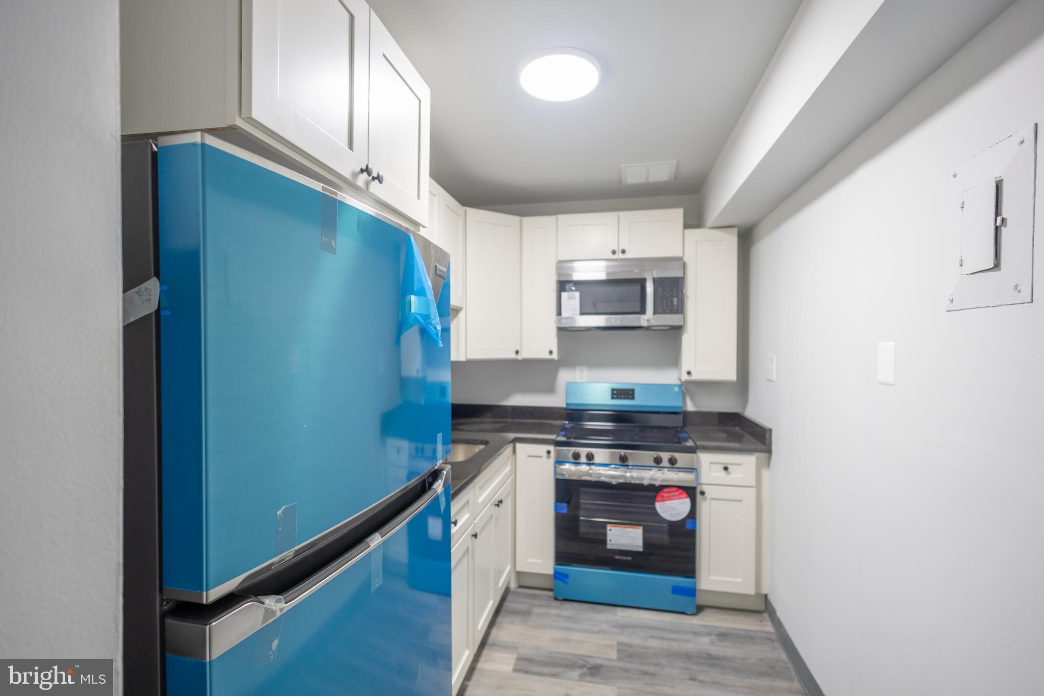 1300-1302 Morris Road Southeast, Unit A6 Washington, DC 20020 - Photo 12 of 13 a kitchen with stainless steel appliances granite countertop a stove a refrigerator and a sink