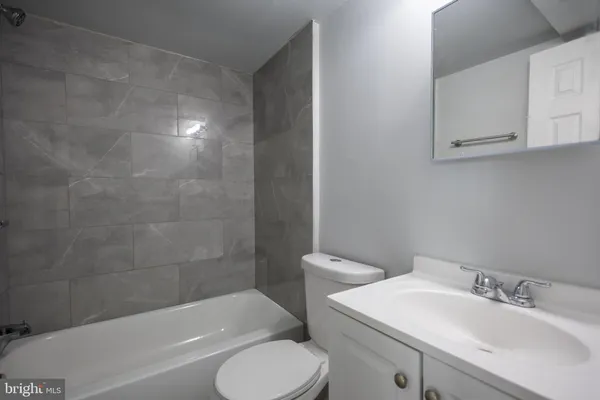 a bathroom with a sink toilet and bathtub